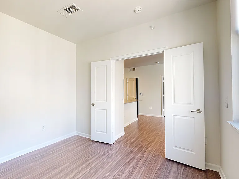 Apartment study with wood-style flooring.