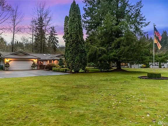Gorgeous setting awaits with mature landscaping wrapping the large, flat grass lawn in privacy
