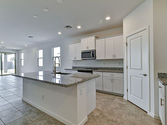 Enjoy white cabinets with hardware and cream black granite countertops in our Crisp package.