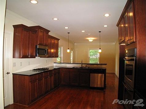 Spacious kitchen with cherry cabinets, granite counters & SS appliances