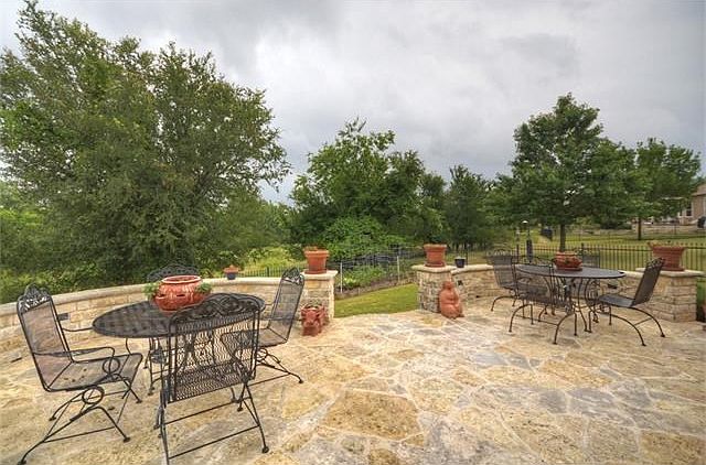 Scenic views of Berry Creek are enjoyed from the Raised Terrace and Stone Patio of this Sun City Texas Cortez located on a tucked-away street near all Three 18-Hole Golf Courses.
