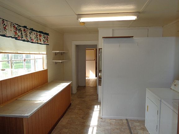 Large utility room with new vinyl flooring. Washer and dryer stay.