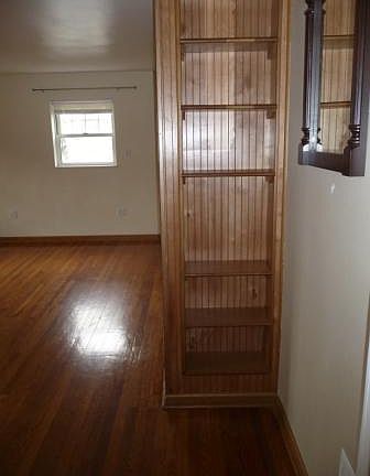 As you enter, you are greeted with this cute shelving divider, mirror and coat area.
