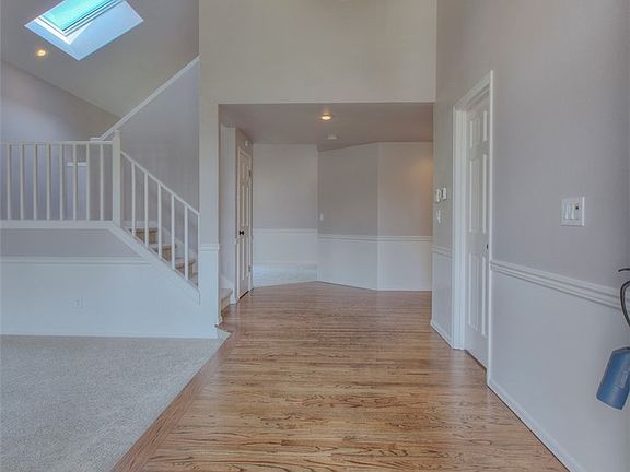 Large Entry with New Hardwood Floors and Vaulted Ceilings Welcome you.