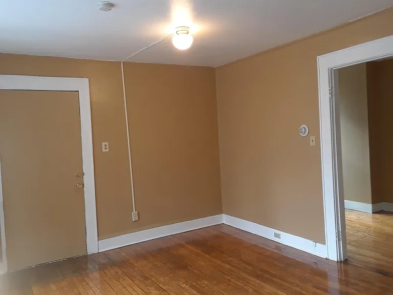 Living room looking at front entry and bedroom