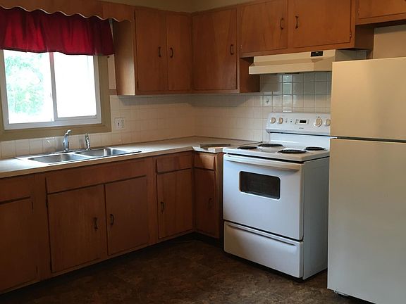 Kitchen with stove, refrigerator, double sink and lots of cabinets!
