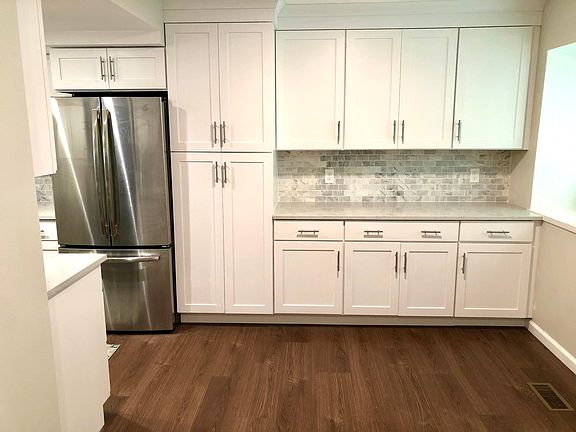 Marble backsplash and large cabinets for plenty of storage