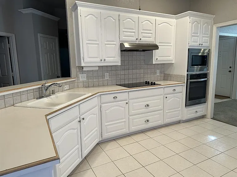 Clean, light and bright. Lots of cabinets. Tile flooring is easy to maintain.