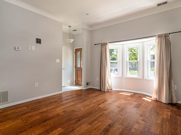Sunken living room has windows that allow a lot of light.