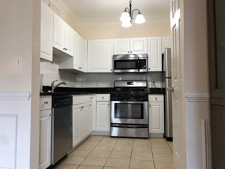 Kitchen with granite countertop and stainless steel appliances