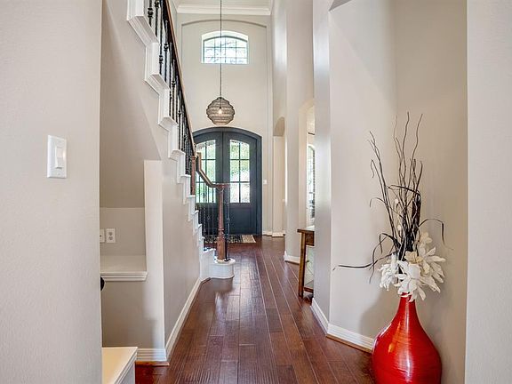 A generous 2 story foyer and gleaming hardwood flooring impress you as you enter the home.