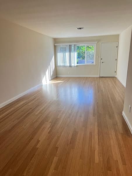 Living Room from Dining Room, showing refinished hardwood flooring, new blinds