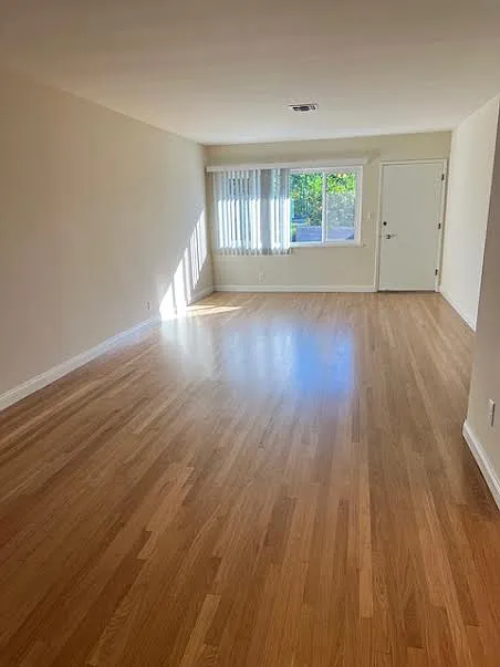 Living Room from Dining Room, showing refinished hardwood flooring, new blinds