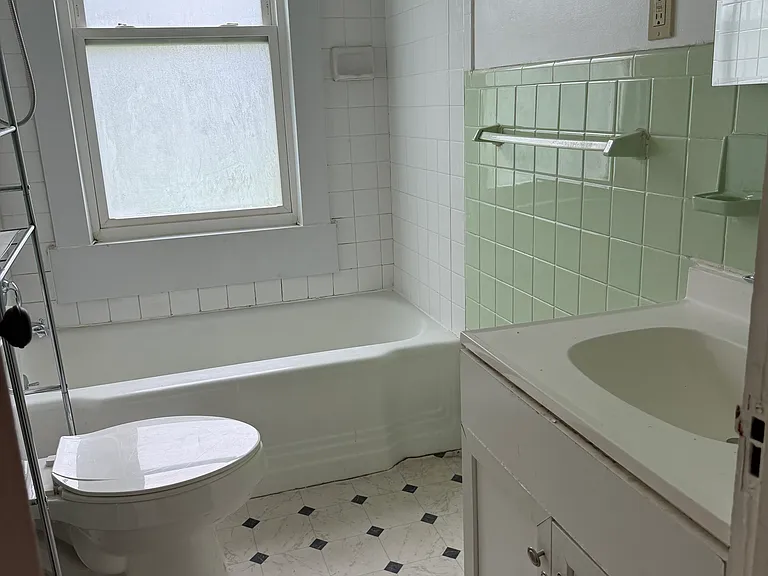 Freshened bathroom has new fixtures, medicine cabinet, sconces