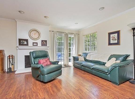 Living room includes a fireplace and vinyl sliding dual pained patio doors.