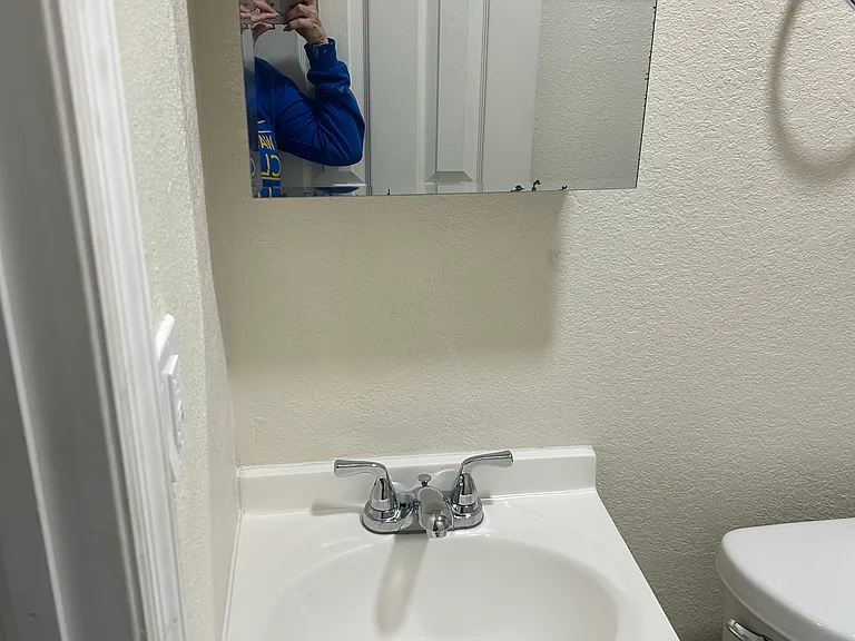Updated bathroom vanity with storage cabinet and modern fixtures.