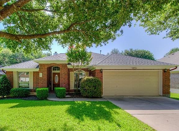 Welcome home! You'll love pulling up to this beautiful home with a well manicured yard and large trees for extra shade. The walkway will take you right to the covered brick entryway.