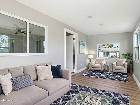 Enclosed Porch virtually staged to show what could be done with the space. No furnishings are included.