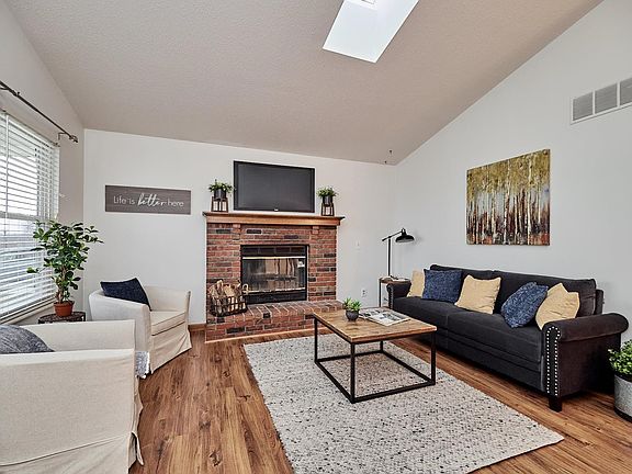 This light-filled home includes some fresh paint, woodburning fireplace, newer flooring, and a vaulted Great Room