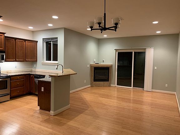 Gas fireplace and sliding door to deck and fenced backyard.