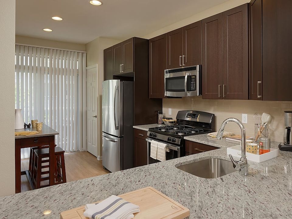 Espresso Finish Package kitchen with granite countertops, stainless steel appliances and hard surface flooring