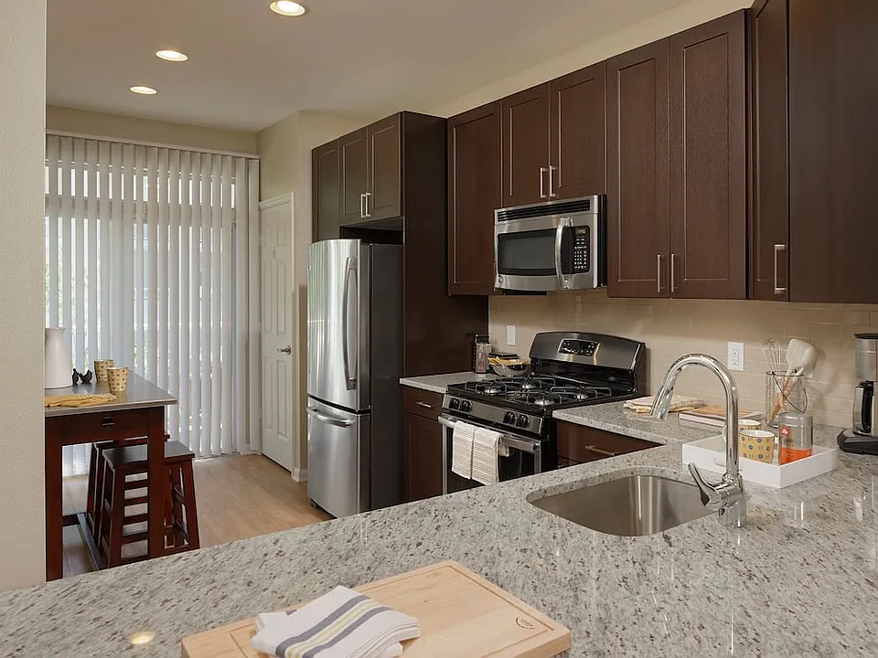 Espresso Finish Package kitchen with granite countertops, stainless steel appliances and hard surface flooring