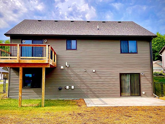 Exterior Back (featuring newly installed patio and fence)