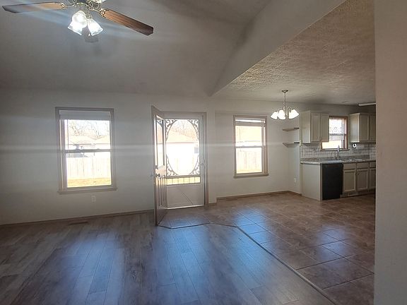 Open concept living room, access to back patio and yard