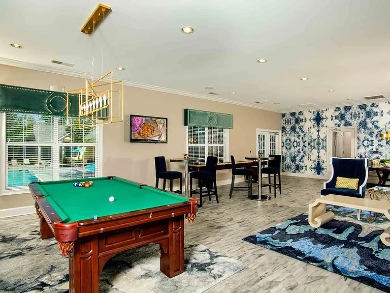 Entertainment lounge with pool table, games, and TVs