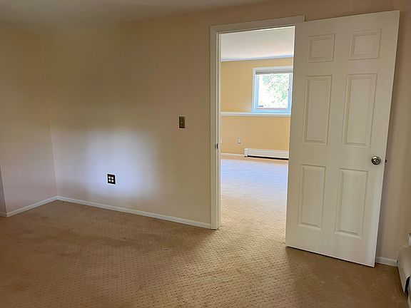 Unit B 2nd bedroom looking through the door into the living space.