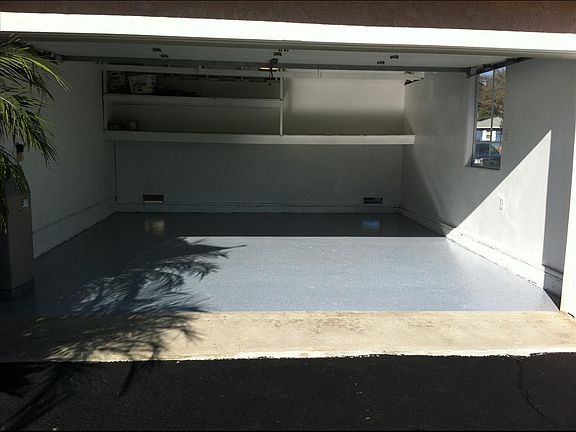 A Man's Garage is his Castle... or storage... rafters offer additional storage above the garage door..