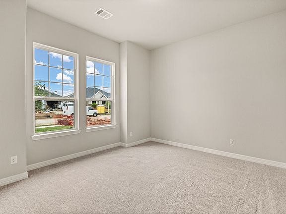 Secondary bedroom is perfect for an in-law suite located on the first floor and features plush carpe