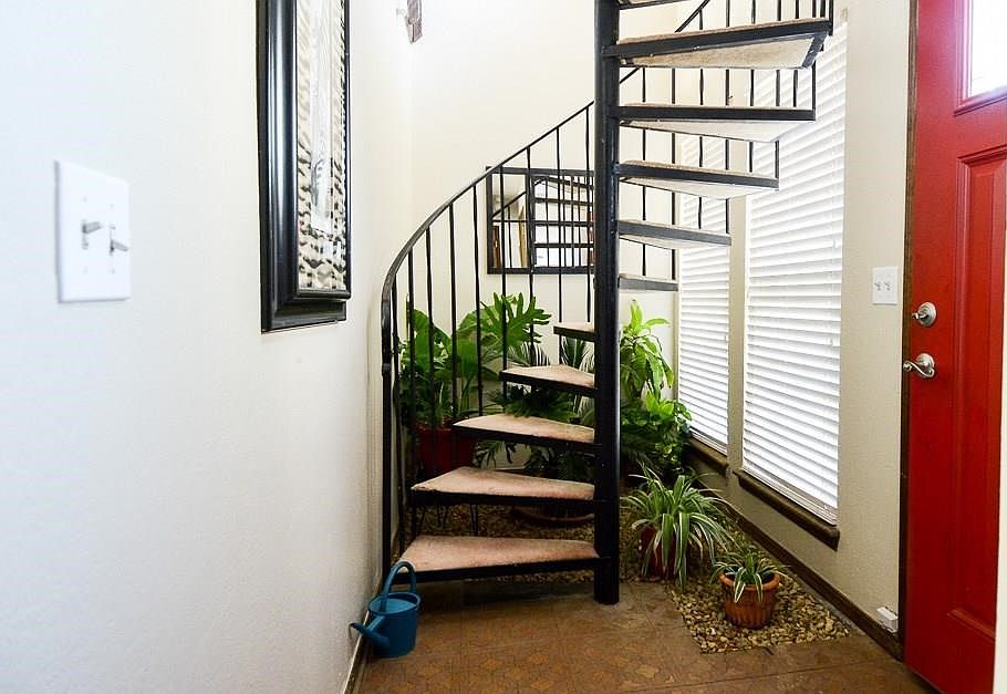 Dramatic entry with spiral staircase to 2nd bedroom/loft overlooking living area