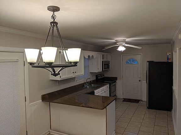 Kitchen with stainless steel appliances and custom granite counters