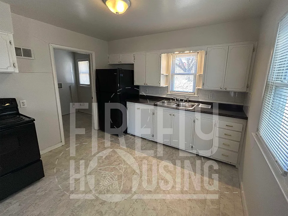 Dine-in Kitchen with great lighting from three windows, ceiling light and above sink light, linoleum floor and electric stove and refrigerator.