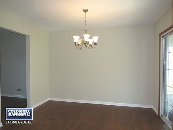 Dining Room with Hardwood Floors and Sliding Glass Door to Sun Room.