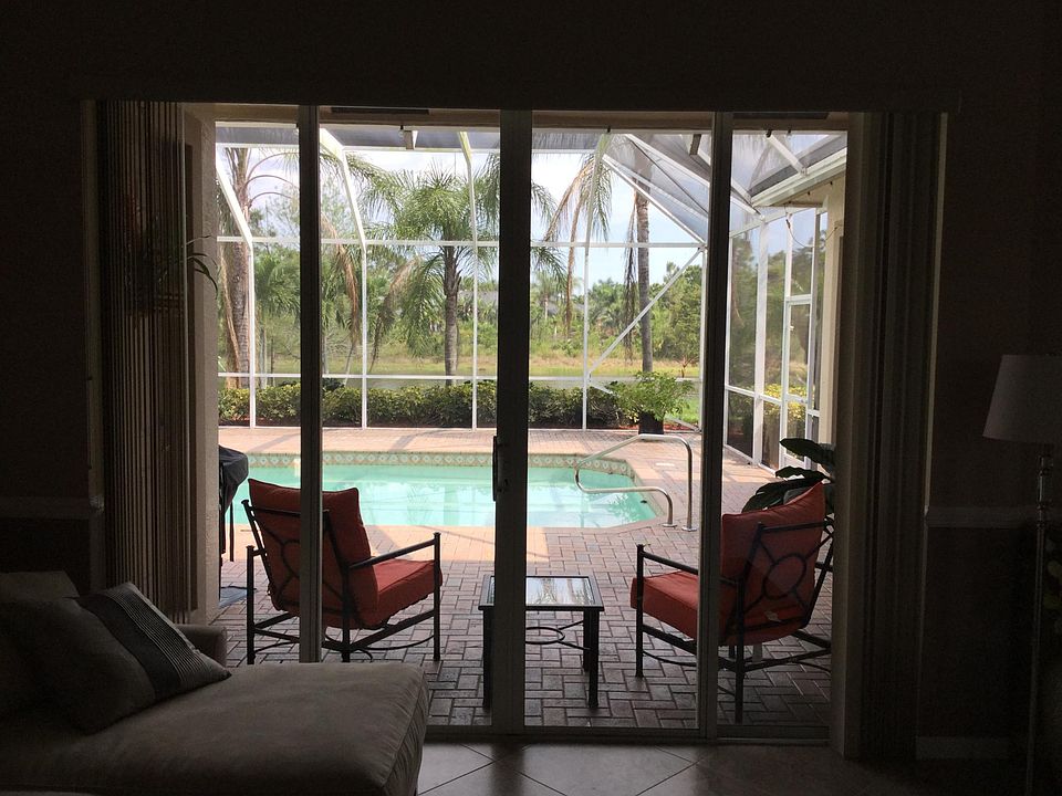 Standing in the living room looking out to the pool and lakeview