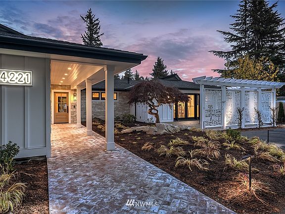 A beautifully presented walk-way welcomes you to this extensively remodeled rambler.  A dreamy front terrace is screened  by a decorative partition.