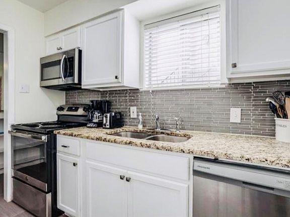 Granite counter tops with newer appliances. The washer and dryer are included. Located in the kitchen