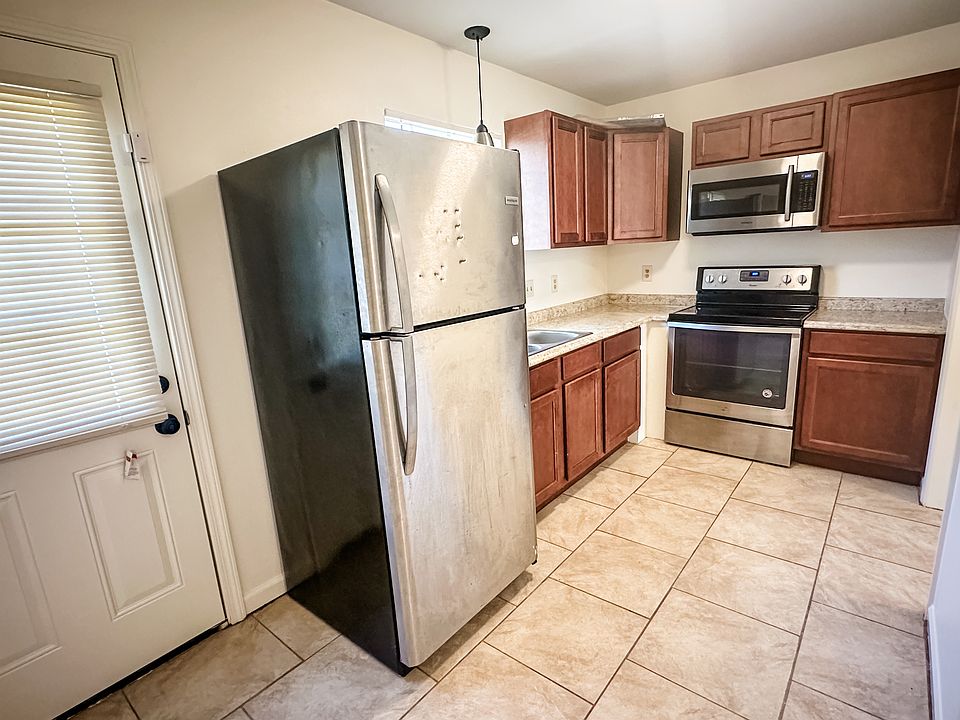 Kitchen with rear exit door.
