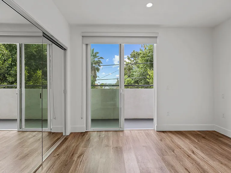 Bedroom with Balcony, Mirrored Closet, Recessed Lighting, and Vinyl Flooring