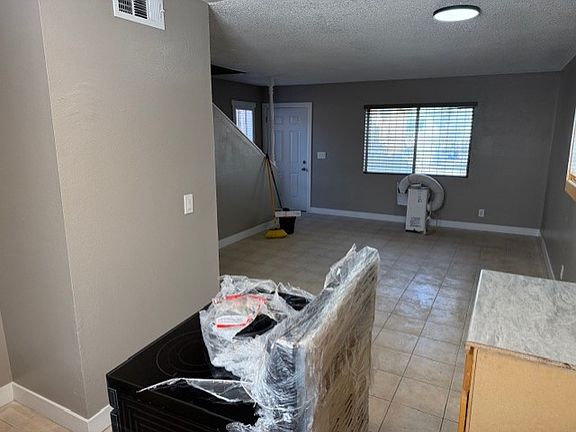 View from Kitchen through Living Area toward Entry Door