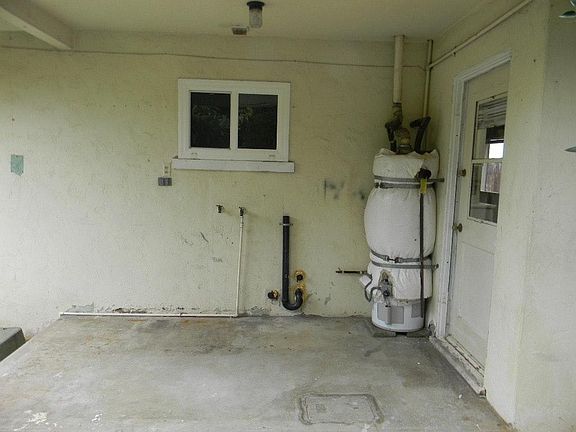 Private covered laundry area wit space for full size washer and dryer