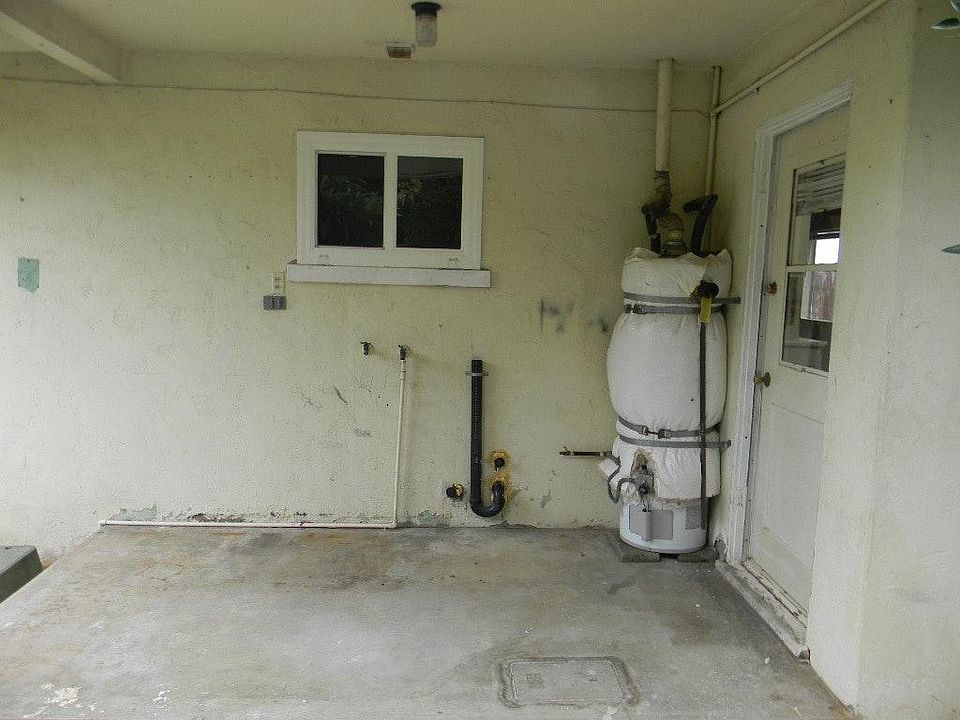 Private covered laundry area wit space for full size washer and dryer