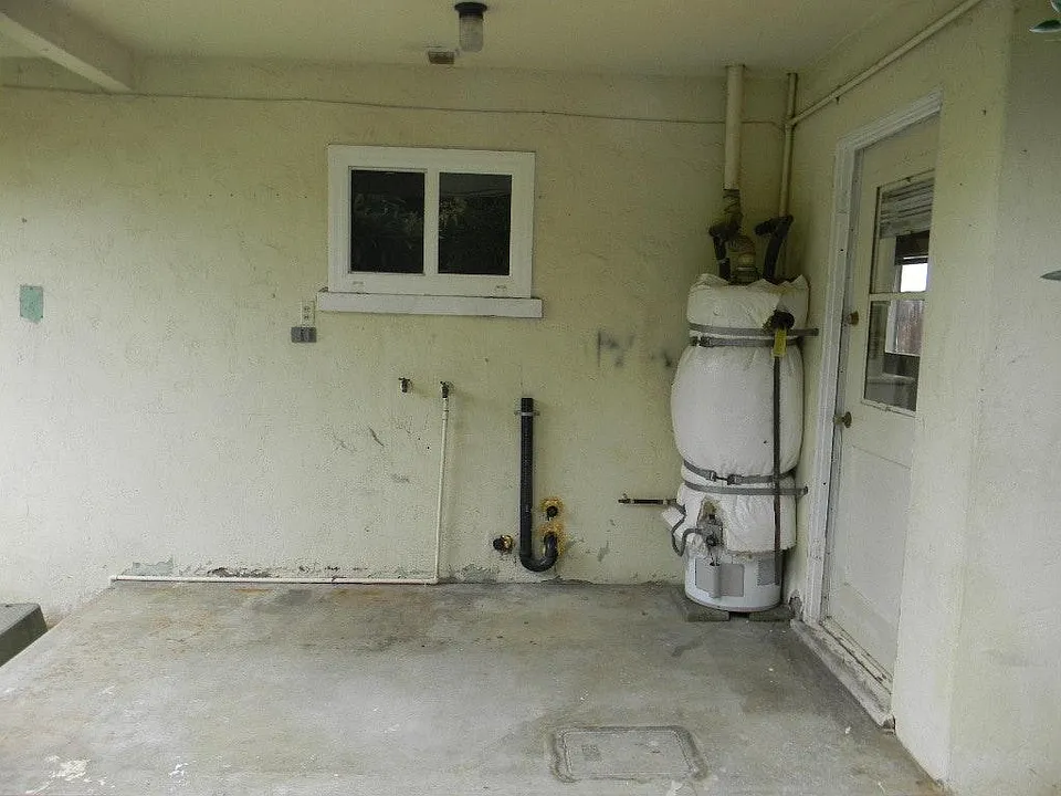 Private covered laundry area wit space for full size washer and dryer
