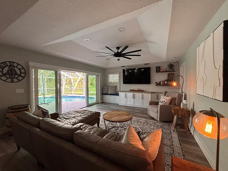 Living rooms space with beautiful view of the pool and patio. 70" smart TV. Sonos speaker for music play.