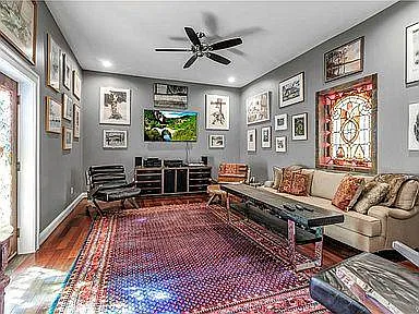 tv-room connected to the kitchen and with stained glass door leading to the rear deck
