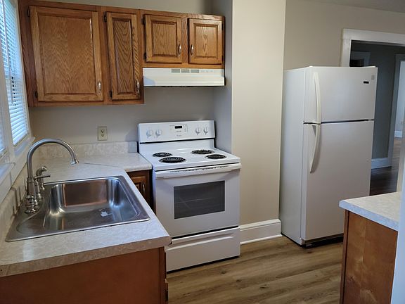 Looking into Kitchen from top of the stairs from the basement. Stove and Refrigerator provided