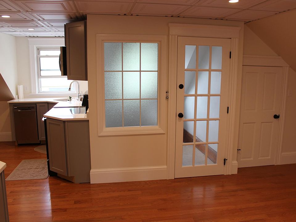 View partial view of kitchen w/ window and rear landing view through French door.