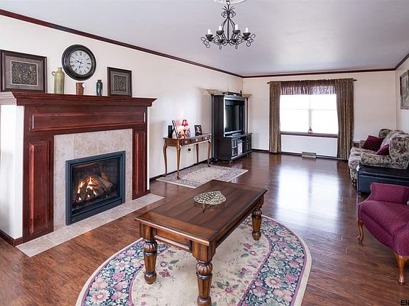 Spacious room with crown molding, wood  flooring and new fireplace!